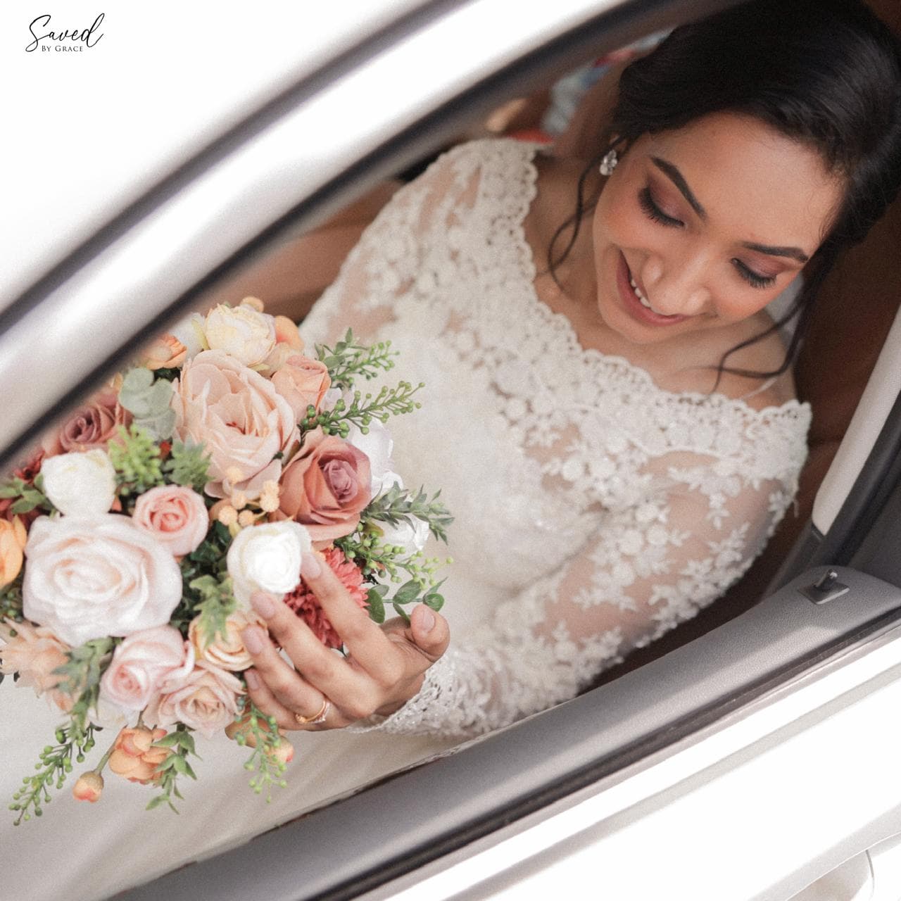 Lumiere Gown: bride with floral bouquet in lace gown